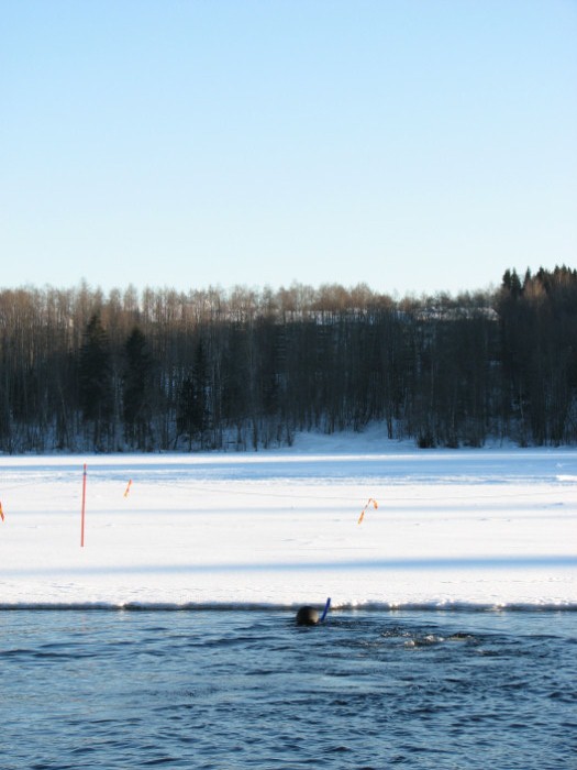 Free-diver in a freezy Finnish lake.