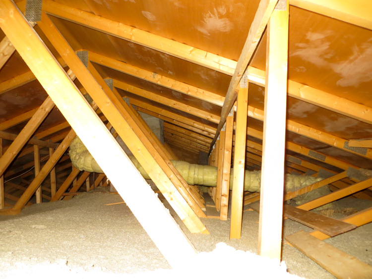 Attic wiht blown cellulose and properly insulated ventilation pipes in cold climate